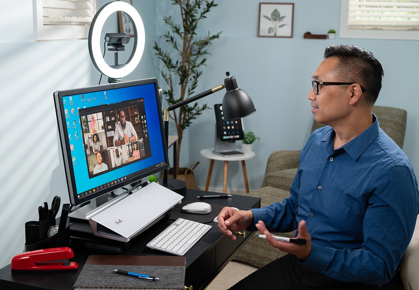 Man working from home with ACCO Brands products on his desk